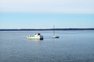 Boat sailing in sea against sky