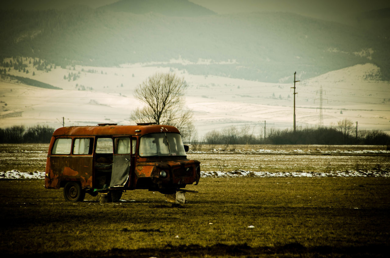 VEHICLE ON FIELD AGAINST SKY