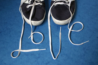 High angle view of love text made with shoelace on floor