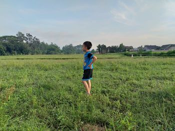 Full length of boy running on field