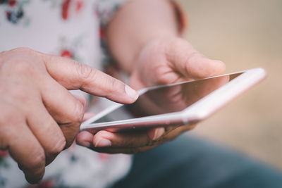 Midsection of man using mobile phone
