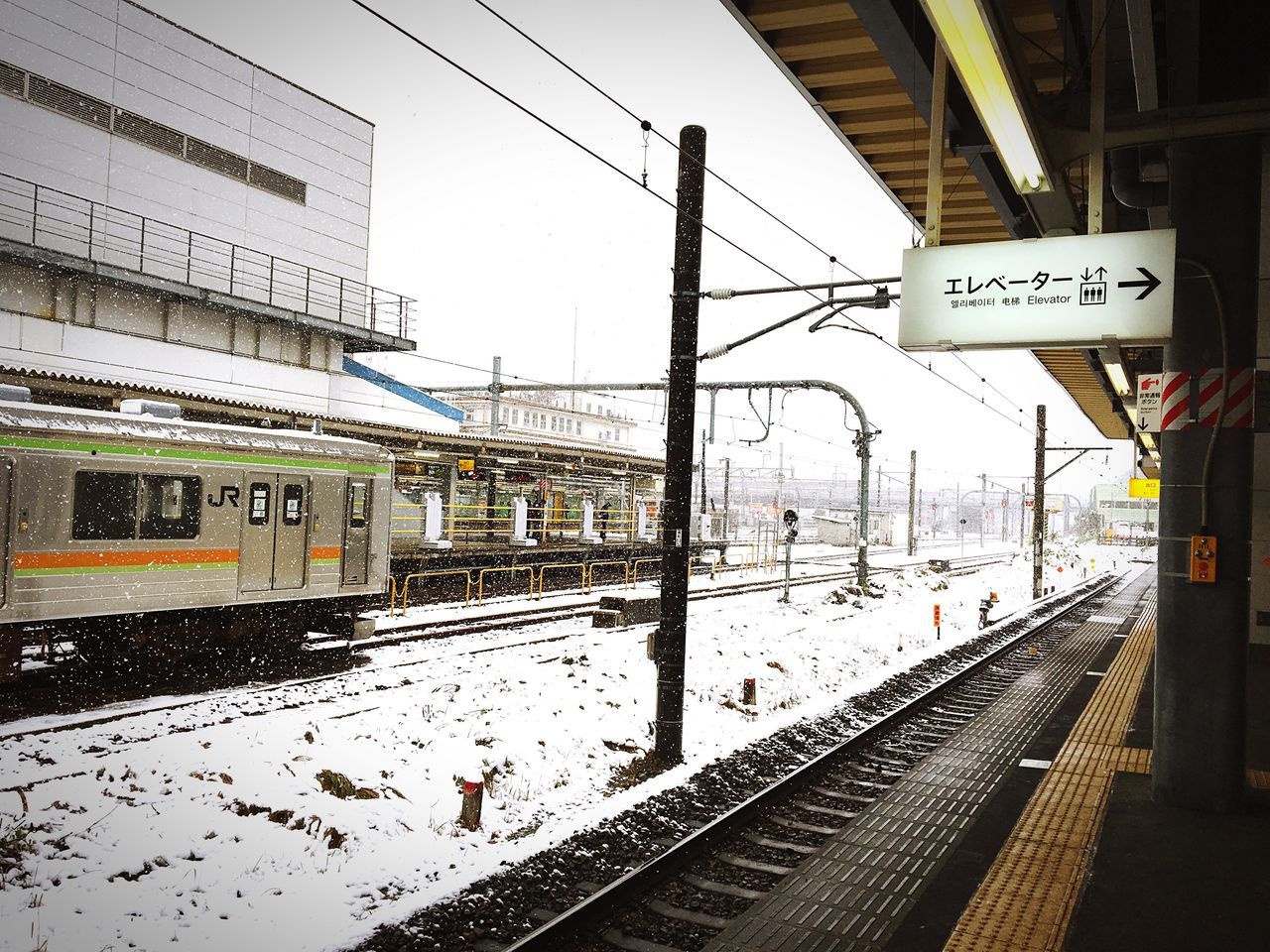 transportation, communication, built structure, text, building exterior, sky, architecture, rail transportation, day, city, no people, outdoors, public transportation, water