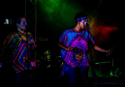 Women singing on stage