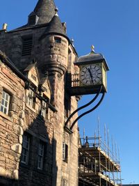 Low angle view of historic building against clear blue sky