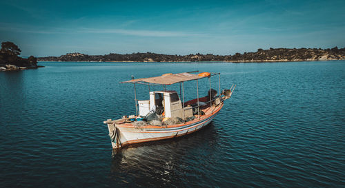 Boat moored in sea against sky