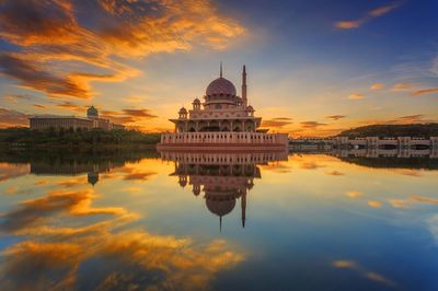 Reflection of buildings in water at sunset