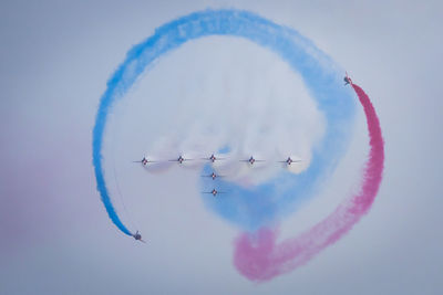 Low angle view of airplane flying against sky