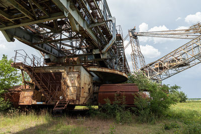 Low angle view of abandoned ship against sky