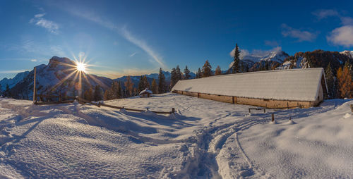 Sunset on alpine hut in front of a beautiful winter panorama, val fiorentina, dolomites, italy