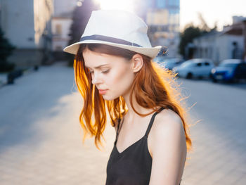 Portrait of young woman wearing hat