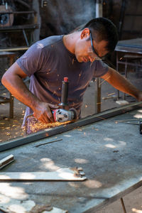 Man working on metal in factory