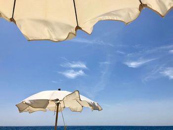 Low angle view of parasol against sky