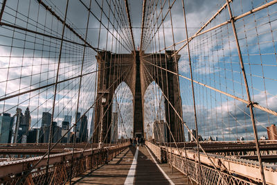 View of suspension bridge against cloudy sky