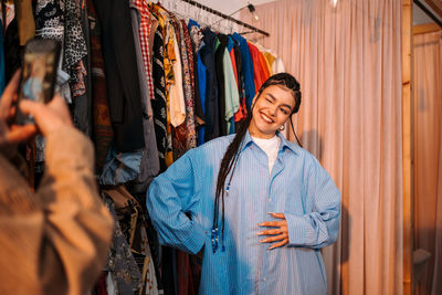 Portrait of young woman standing in store