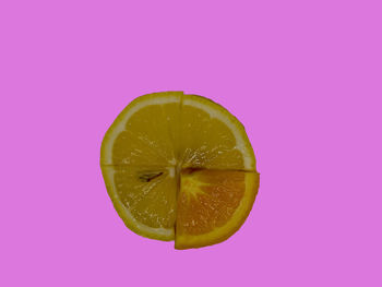 Close-up of lemon slice against pink background