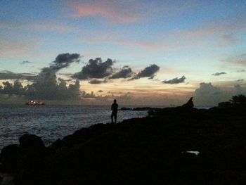 Silhouette of people standing on beach