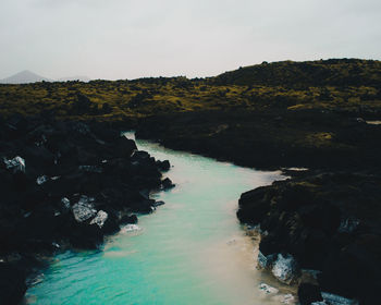 Scenic view of sea and rocks against sky