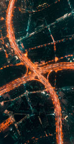 Aerial view of light trails on street in city at night