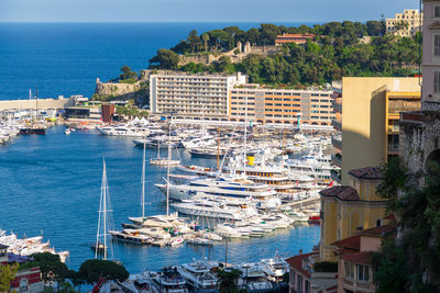 High angle view of townscape by sea against sky
