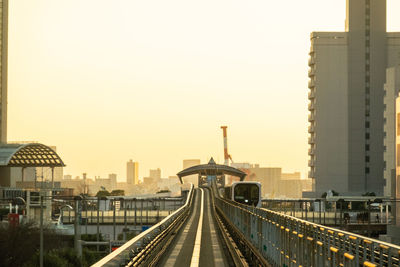 Bridge in city against clear sky