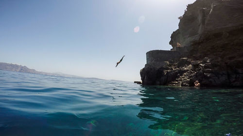 Man diving in sea from cliff