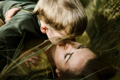 Mother kiss her little son outdoor