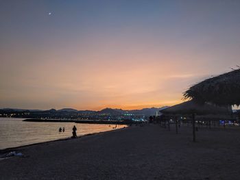 Scenic view of beach against sky during sunset