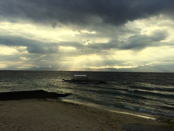 Scenic view of sea against cloudy sky