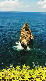 Scenic view of rock formation in sea against sky