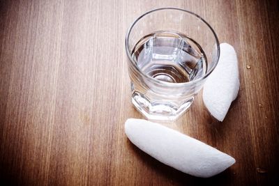 High angle view of water in glass by dry ice on table