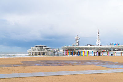 Pier on beach against sky