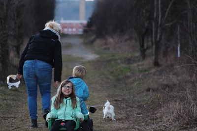 Family with dog on footpath