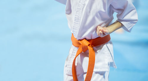 Midsection of man practicing karate 