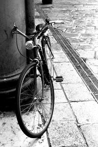 Close-up of bicycle on sidewalk