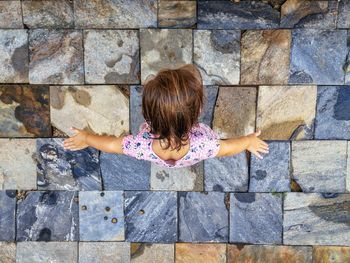 Full length rear view of woman against wall