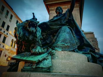Low angle view of statue against building