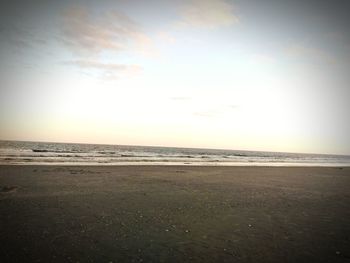 Scenic view of beach against sky during sunset