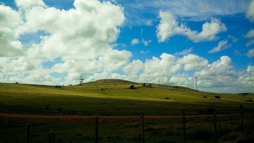 Scenic view of green landscape against sky