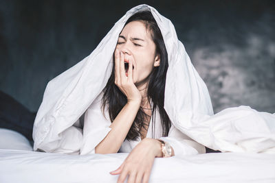 Young woman lying down on bed