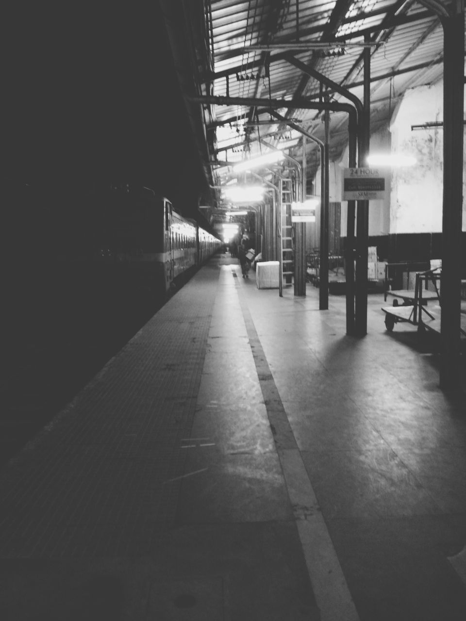 indoors, the way forward, illuminated, architecture, ceiling, diminishing perspective, built structure, transportation, empty, lighting equipment, vanishing point, absence, flooring, long, interior, no people, corridor, incidental people, railroad station platform, in a row