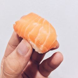 Close-up of hand holding sushi