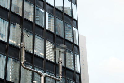 Close-up of modern building against sky