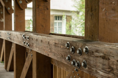 Close-up of bolts on wooden bridge