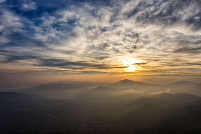 Scenic view of mountains against sky during sunset