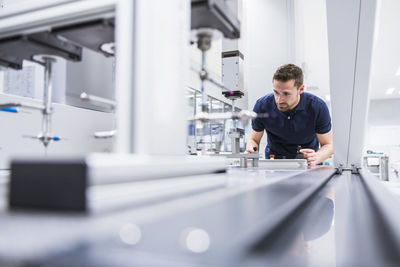 Man operating machine in testing instrument room