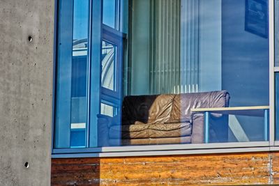 Rear view of woman looking through window