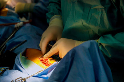 Low section of woman holding messy bed