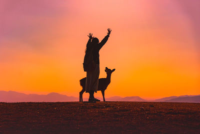 Girl on mount wakakusa with light during a low warm winter sun sight before sunset nara deer 