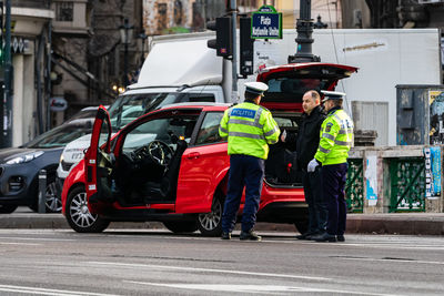 Rear view of people working on road