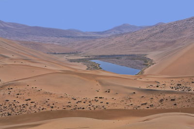 1052 unidentified lake mirrors a megadune of the badain jaran-gobi desert. inner mongolia-china.